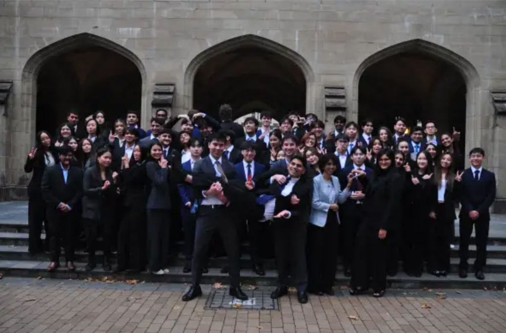 SIIF committee members gathered in front of stone arches
